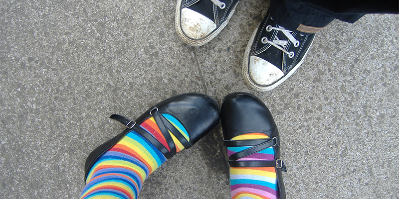 two pair of kids shoes, one mary jane and one canvas